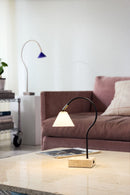 Modern lamp on a coffee table in a living room setting