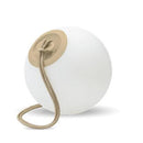White spherical light with a beige rope on a white background. Portable lights that are rechargeable