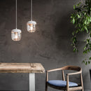 2 White Umage Acorn Glass Lampshades hanging above a rustic table and chair