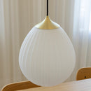 Umage Around the World Glass Lampshade.A white, mouth-blown glass lampshade with a hot air balloon shape, featuring a milky white color, mounted on a metal top, displayed in an interior setting.