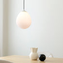 Umage Around the World Glass Lampshade above a dining table.