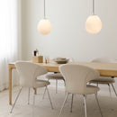 A pair of Umage Around the World Glass Lampshades above a dining table