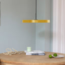 Yellow Umage Asteria Pendant Light above a table