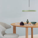 Olive Green Umage Asteria Pendant Light above a table and chair