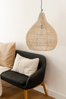 Original Home Bawang Rattan  Lamp shade hung on a pendant light above a chair