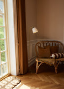 Halo Design Room 49 Floor Light in Opal Antique Brass next to curtain and rattan chair