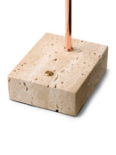 Candle holder made of beige stone with a copper candle stick on a white background