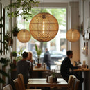 Globe Lampshade hung over tables in a coffee shop. The Rattan lightshades adding to the rustic feel 