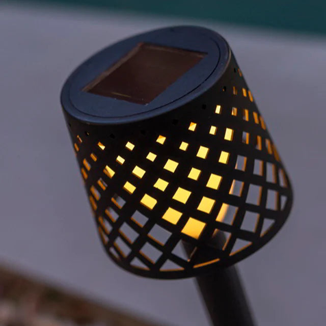 Solar-powered outdoor light with grid design on a blurred background