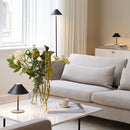 Rechargeable Halo Hygge Table Lamp on a coffee table in front of a sofa and on a sideboard