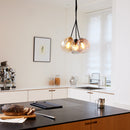 Halo Design Bubbles glass pendant lights in amber, rose and smoke, 14cm pendants hanging in a modern kitchen