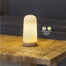 Futuristic cylindrical light on a woven surface with mode indicators.