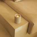 Candle on a beige sofa