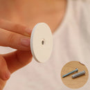 Hand holding a white circular object with a small hole, inset showing two screws.