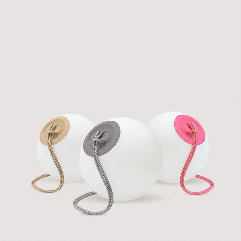 Three spherical objects with colorful hooks on a light gray background