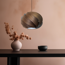 Nuez Laminate Wood Lampshade above a table 
