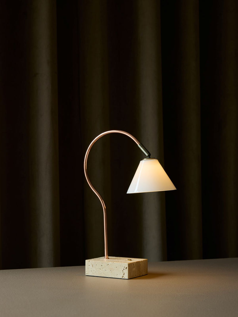 Modern table lamp with a curved design on a dark background