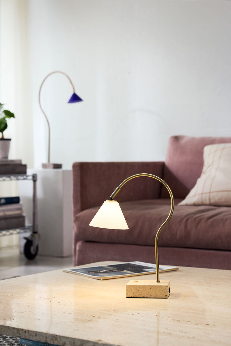 Modern table lamp on a coffee table in a living room setting