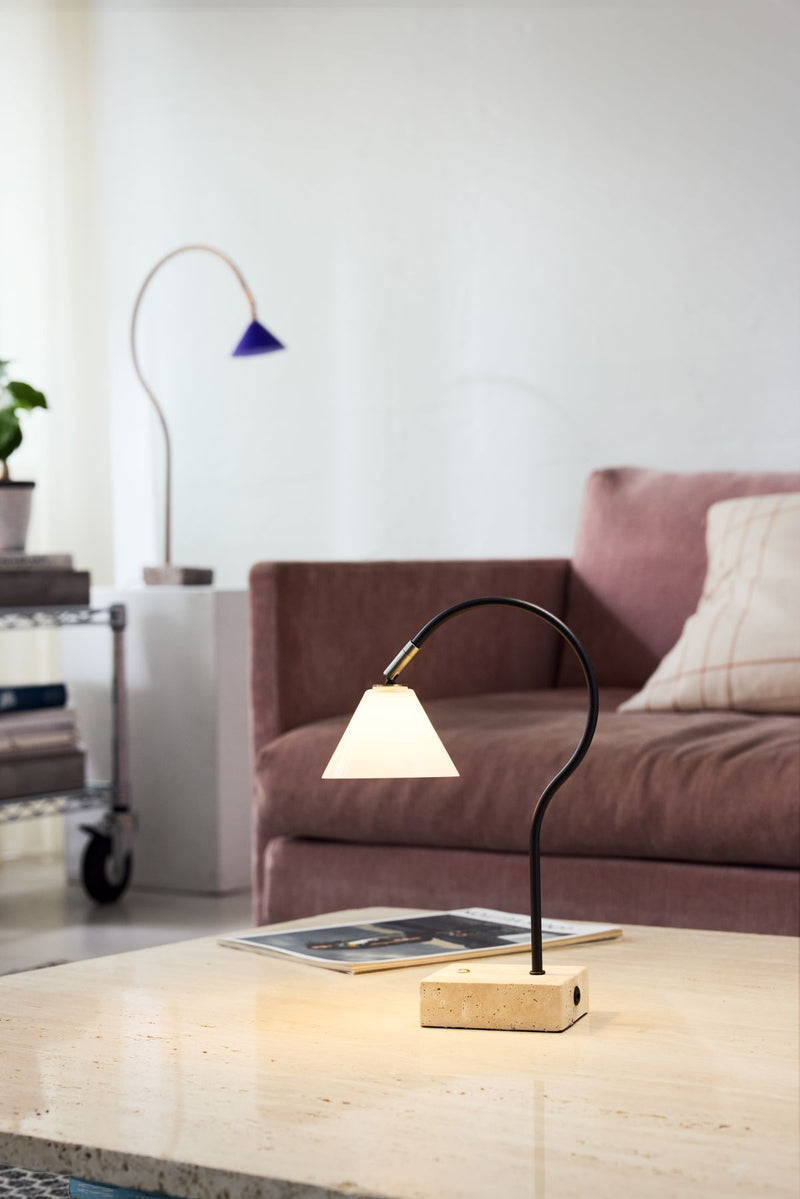 Modern lamp on a coffee table in a living room setting