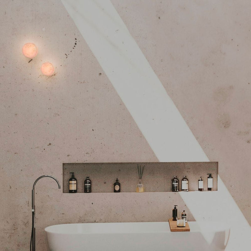 Robin Lamps Rock Wall Light in Black and Alabaster mounted in modern bathroom