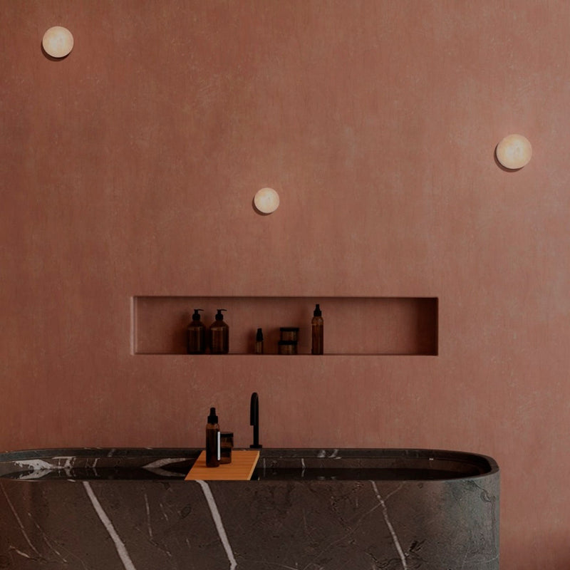 Robin Lamps Rock Wall Light in Black and Alabaster mounted in dark modern bathroom