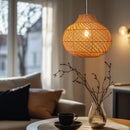 Thatch Jar Rattan Lampshade above a coffee table next to a sofa giving a warm glow