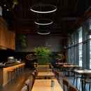 3 Vortex LED Ring Pendant Lightin a row hanging in a restaurant