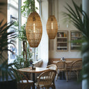 Thatch Cigar Rattan Lampshade above a table and chairs in a Cafe