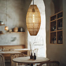 Thatch Cigar Rattan Lampshade by Shropshire Shades in a rustic venue above a table