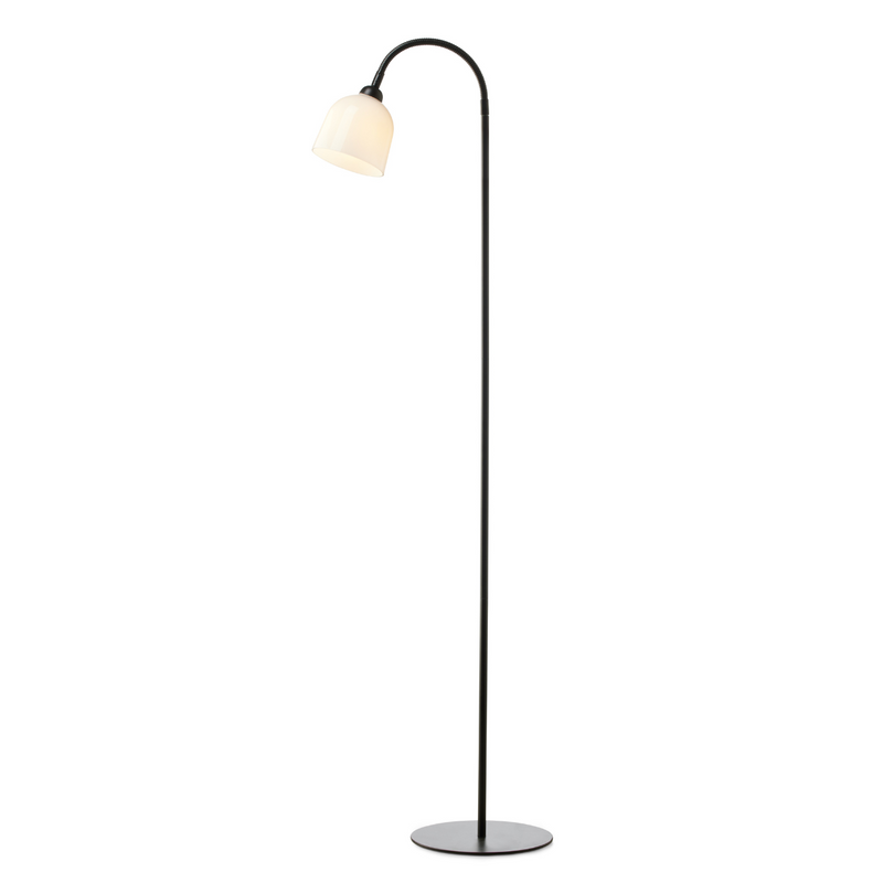 Modern floor lamp with a curved arm and white shade on a white background
