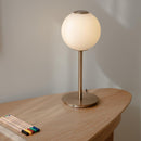 Umage Audrey Spherical Glass Table Lamp on a table with pencils and a ruler