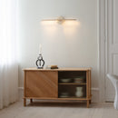 Umage Omni Wall Light Horizontally placed above a sideboard