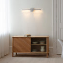 Umage Omni Wall Light in Brushed Steel above a sideboard