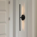 Umage Omni Wall Light in Black positioned Vertically in a narrow space on a wall