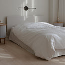 Horizontal Black Umage Omni Wall Light above a bed