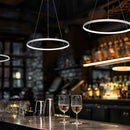 3 suspended Vortex LED Ring Pendant Lights over a bar area