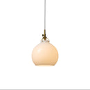 Halo Design Toscana pendant light in opal, small 18cm milky glass sphere with antique brass fitting on white background