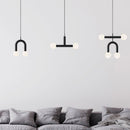 all Rigoberta pendant light variants hanging above a grey sofa against a light grey wall.