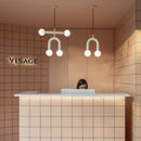 Robin Lamps Rigoberta Pendant Light Matte White Duo Super Curved in a boutique salon interior