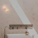 Robin Lamps Rock Alabaster Wall Ceiling Light installed above freestanding bathtub in minimalist bathroom
