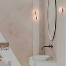 Robin Lamps Rock Alabaster Wall Ceiling Light in bathroom next to round mirror and vessel sink