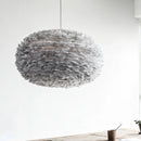grey Umage pendant lampshade hanging in a white showroom