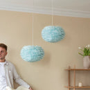 light blue Umage pendant lampshades hanging in a cotemporary living room