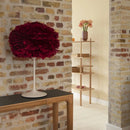 mini red Umage table lampshade sitting in rustic brick hallway