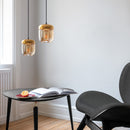 Apair of Umage Acorn Glass Lampshades  in amber  above a black table and chair