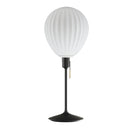 Around the world table lamp by Umage, inspired by the shapes of hot air balloons. A white glass lampshade and elegant Santé table base in black