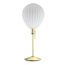 Around the world table lamp by Umage, inspired by the shapes of hot air balloons. A white glass lampshade and elegant Santé table base in brass