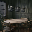 3 Pilke Signature 18 Wooden Pendant lights in Black above a dining table