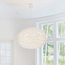 Large Feather Lampshade by Umage on a pendant light in a room in front of a window.