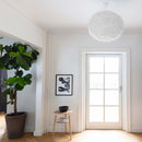 Large White Feather Lampshade by Umage in a room setting on a pendant light
